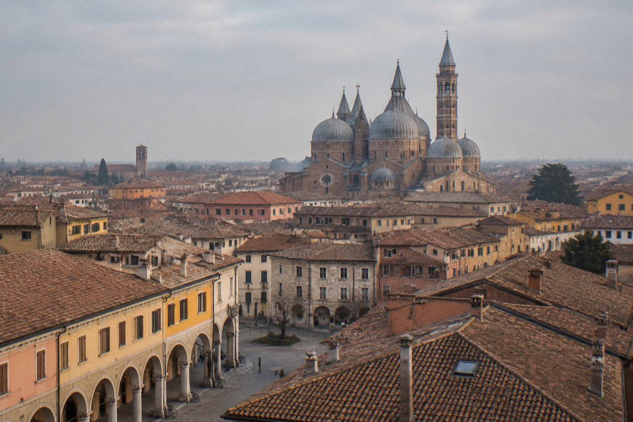 Aerial view over Padua's rooftops with the Basilica of Saint Anthony's domes rising above the tile roofs