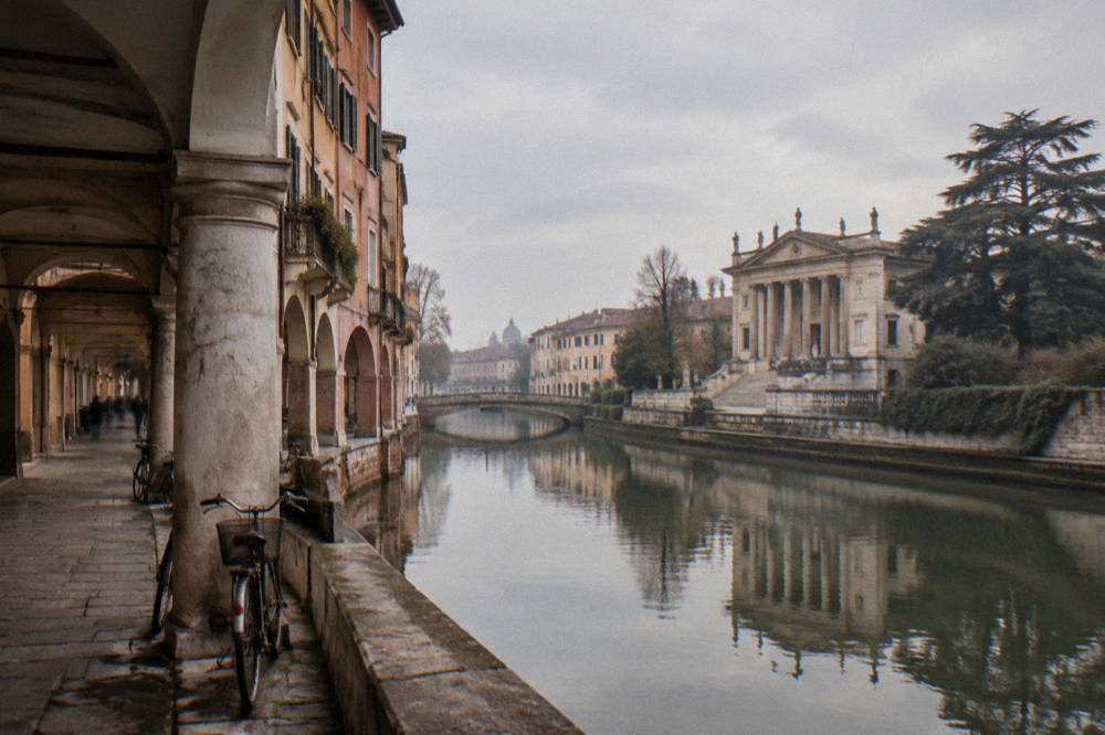 Palladian-style riverside villa with a classical facade reflected in a slow river
