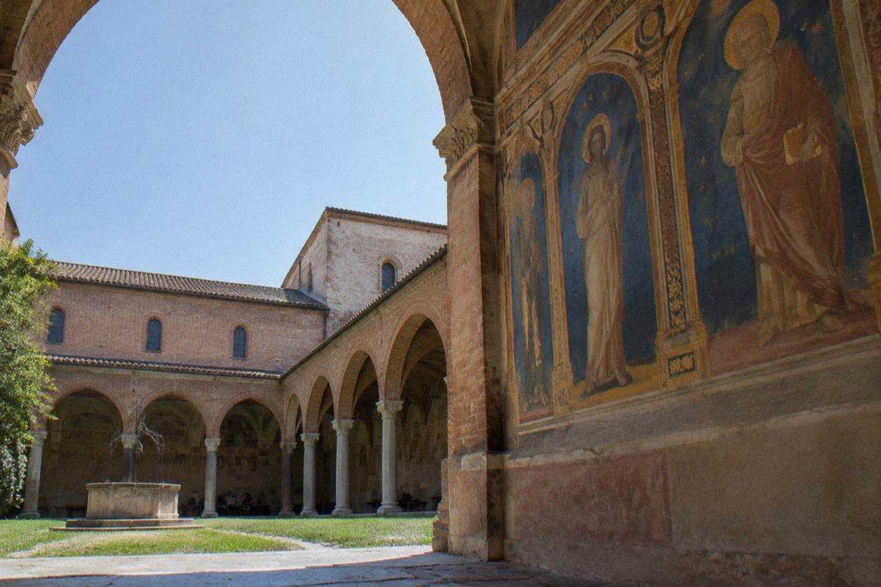 Frescoed interior wall of a medieval chapel with blue and gold painted panels