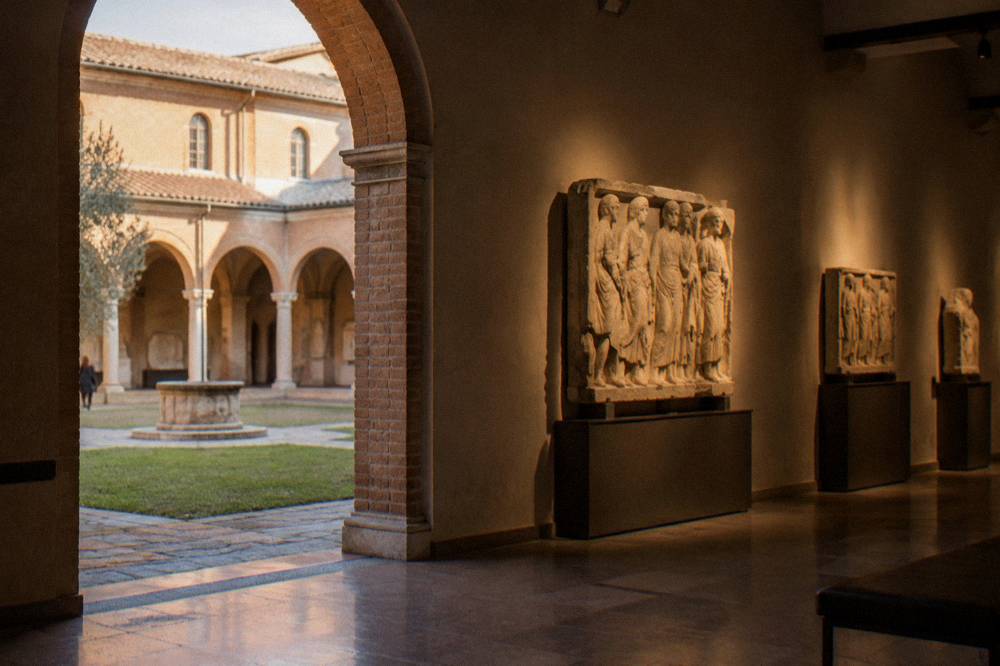 Museum hall with archaeological stone reliefs displayed under spotlights