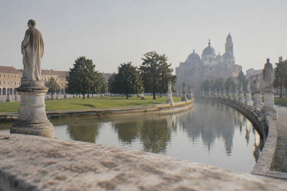 Wide view of Prato della Valle square in Padua with its canal ring and rows of statues