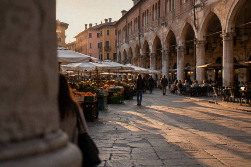 Evening light on Piazza delle Erbe in Padua with outdoor tables under the arcades