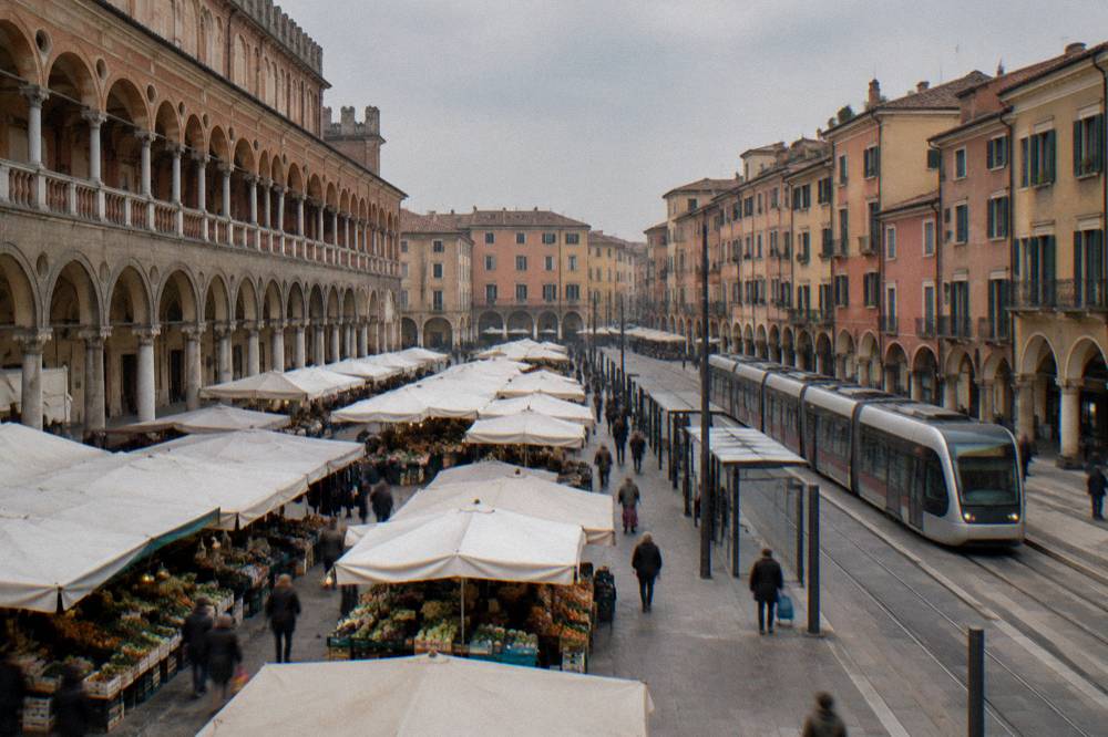 A tram passing modern stops on an Italian city street