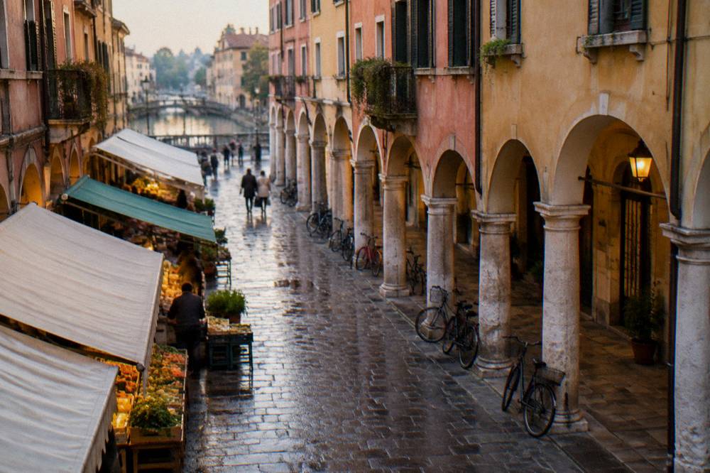 An arcaded street in Padua's historic centre with market awnings and bicycles in the evening