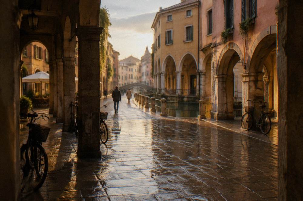Wet cobblestone street in Padua with reflected lights after rain