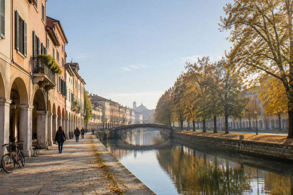 Autumn trees along a canal in Padua with golden leaves