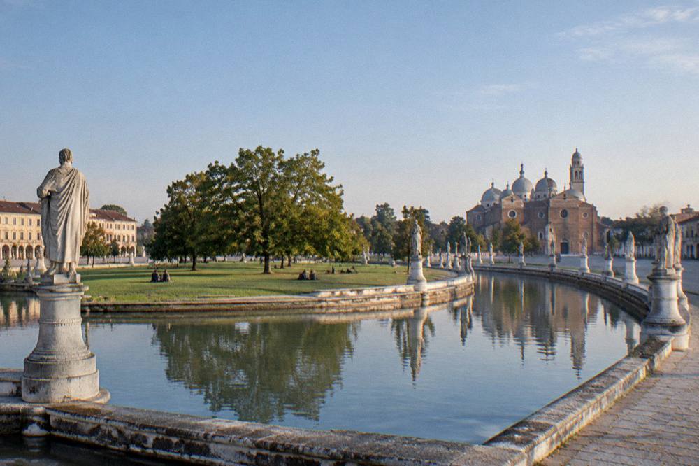 The canal and ring of statues surrounding the island of Prato della Valle in Padua on a clear day