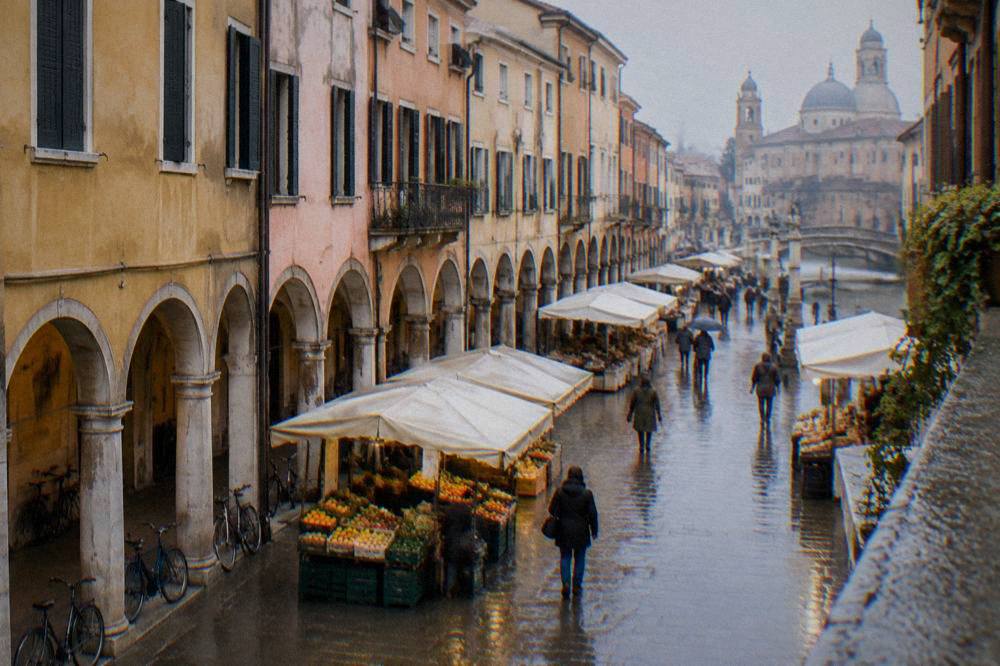 Arcaded street and market stalls in central Padua on a walk between sights