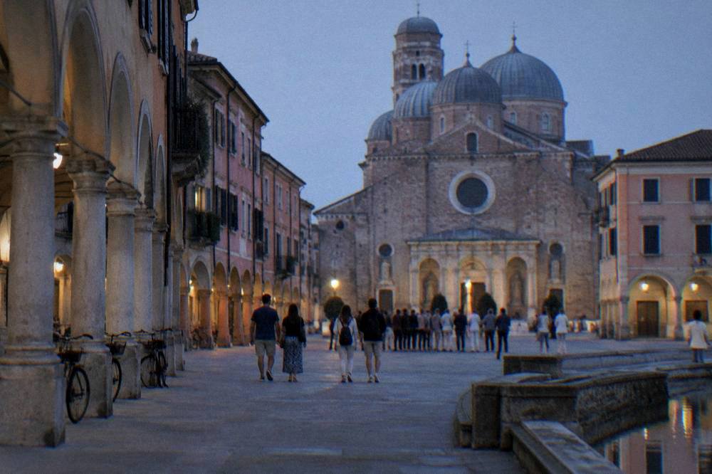 Tourists on the square outside the Eremitani complex in Padua before a chapel visit