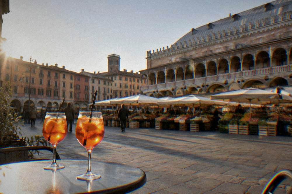 Orange spritz glasses on a stone table, no labels