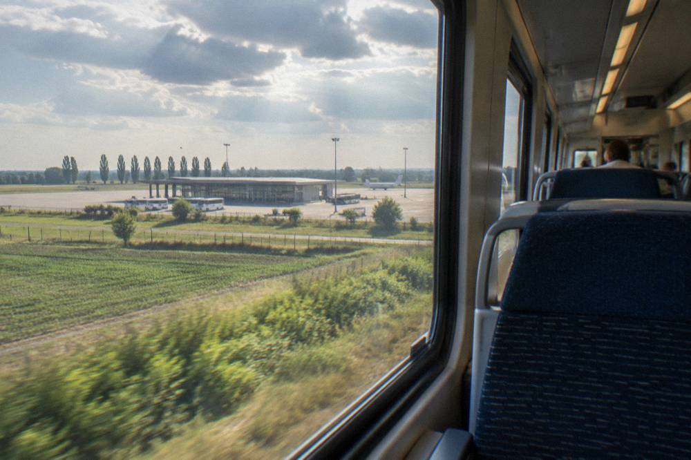 The interior of a modern Italian railway carriage with rows of seats