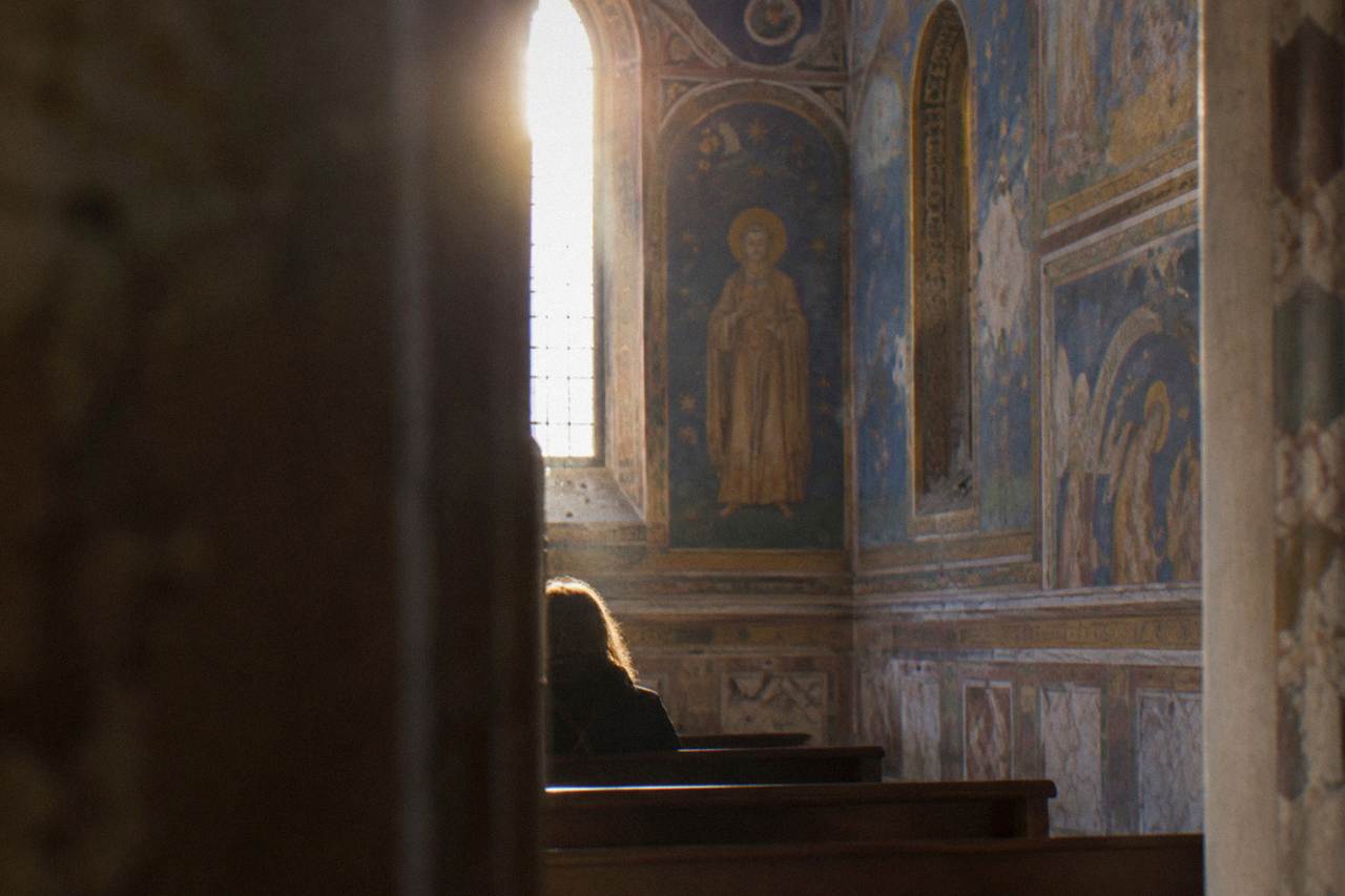 The blue and gold frescoed interior wall of a small medieval chapel in Padua
