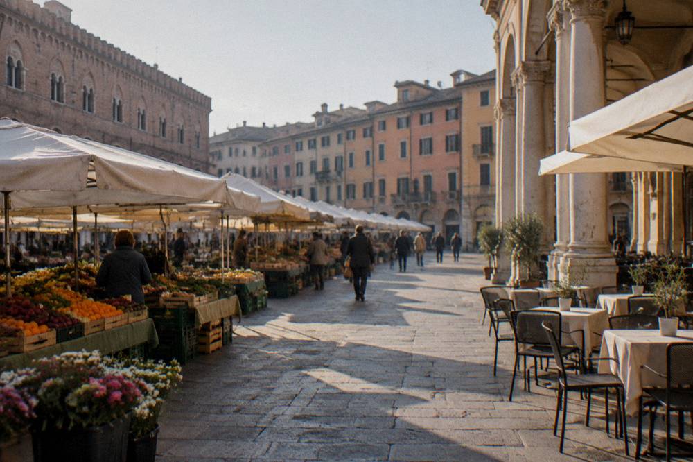 The neoclassical facade of a historic Italian cafe with tables on the pavement