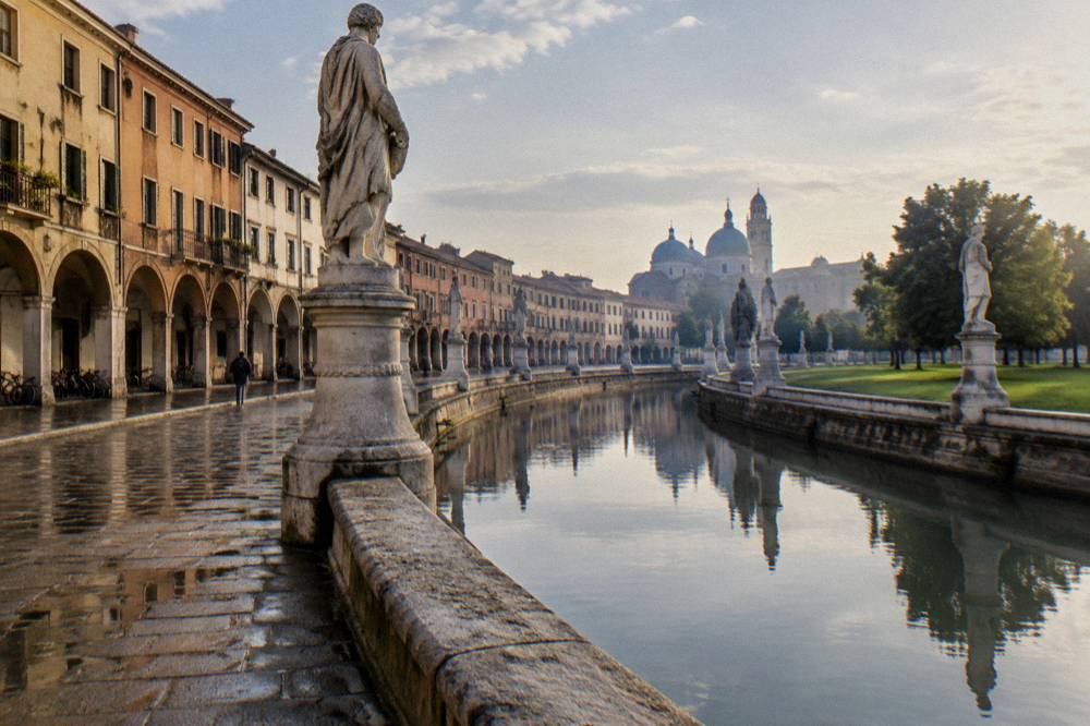 A broad oval square in Padua with a central island surrounded by a canal and rows of statues