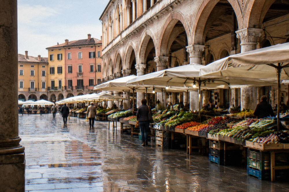 Market stalls under the arcades of Piazza delle Erbe in Padua