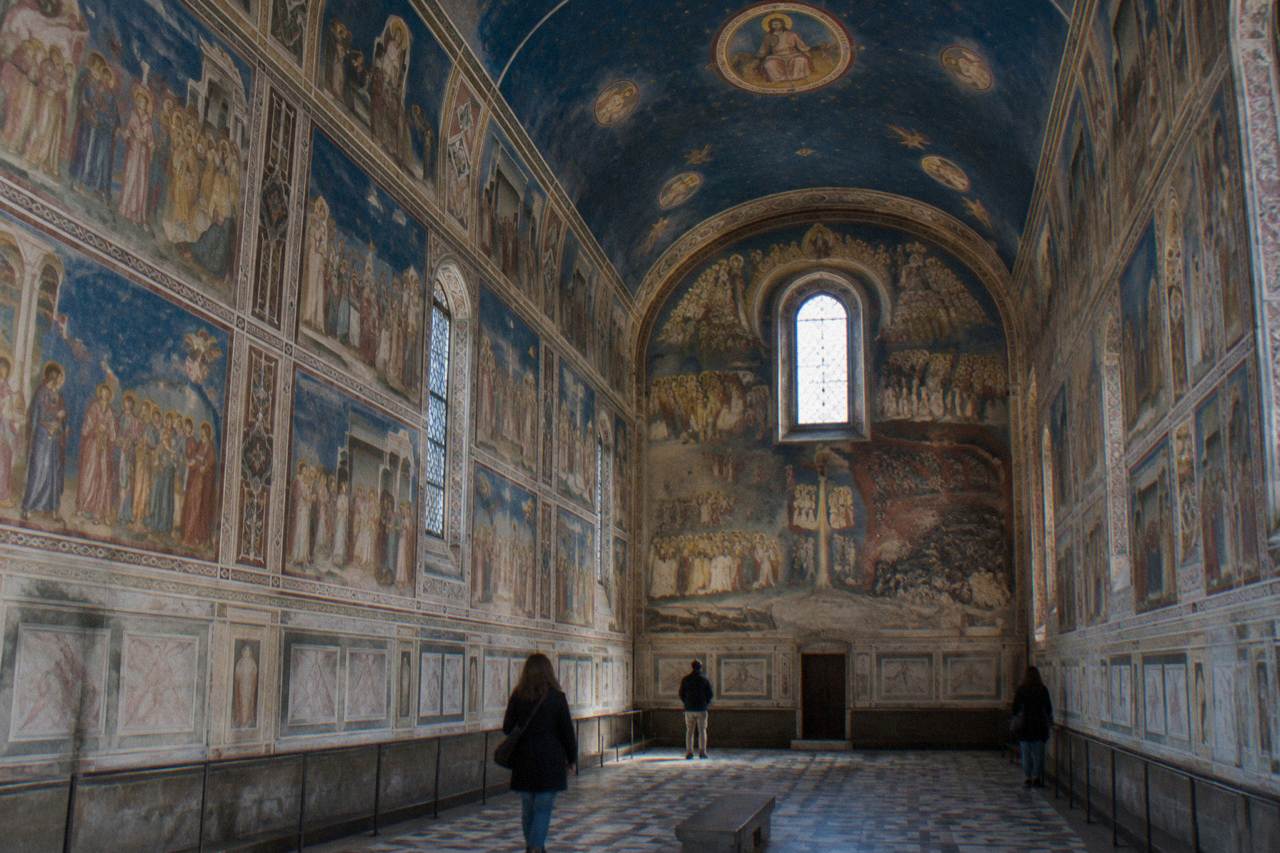 The frescoed interior of the Scrovegni Chapel in Padua, with blue and gold narrative scenes covering the walls and vault