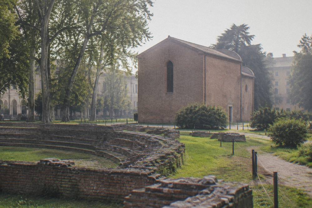 The brick exterior of the Scrovegni Chapel in Padua seen from the gardens of the Eremitani museum complex