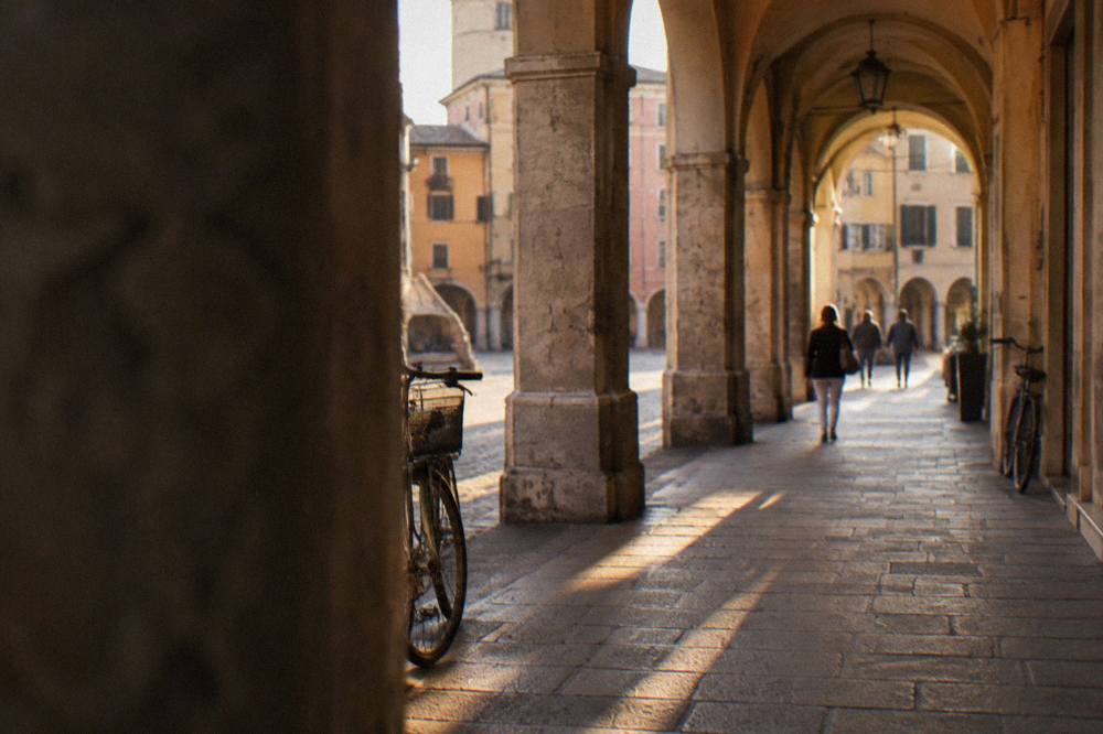 The porticoed street of Via Roma in Padua leading toward the historic centre in evening light