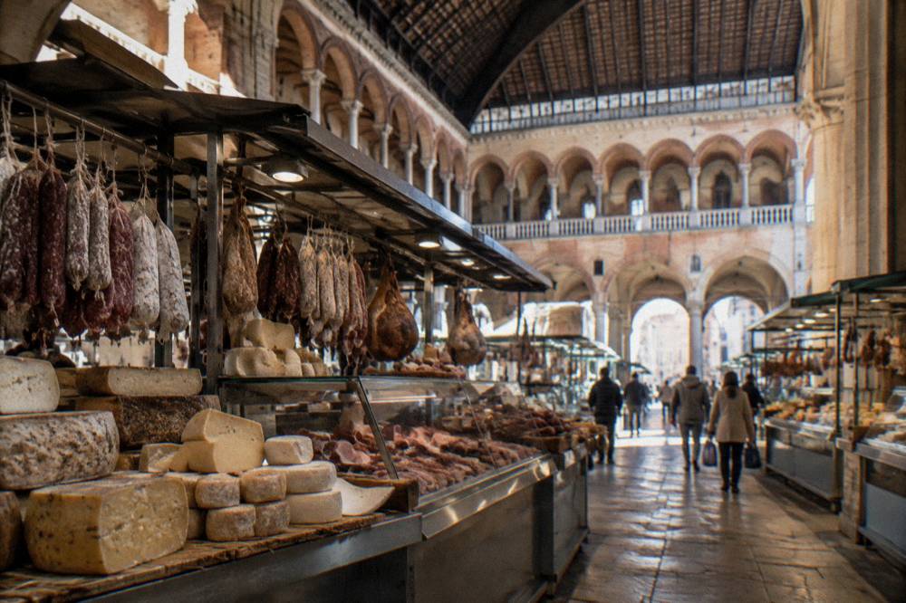 Interior of a covered food market with cheese and cured meat counters