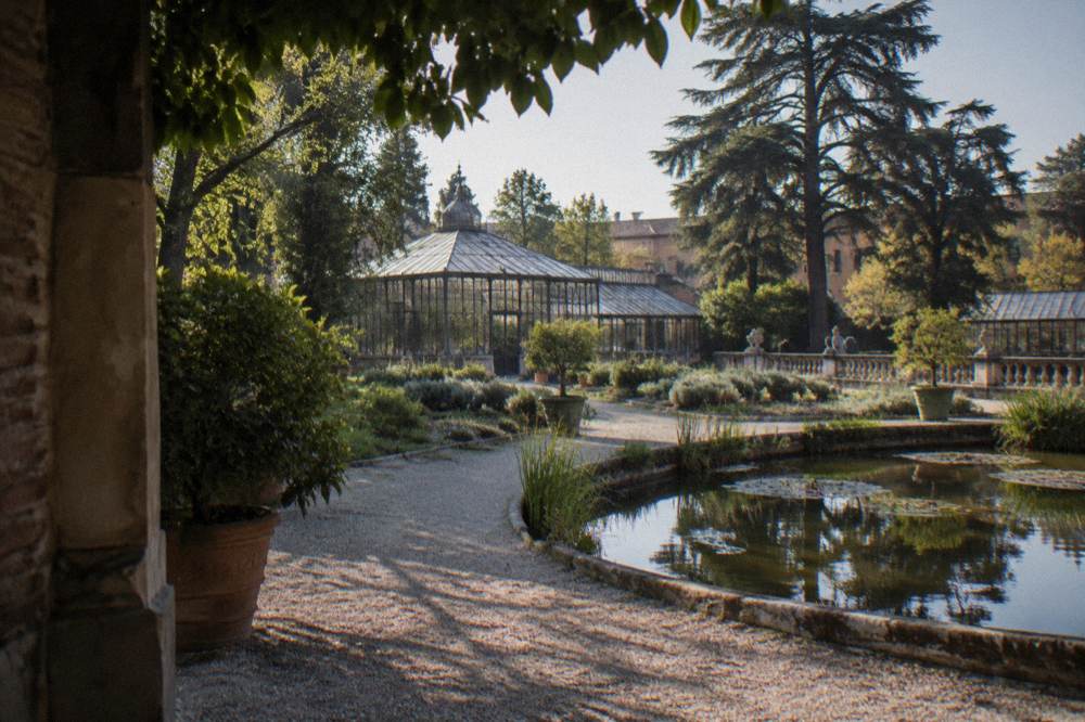 Historic botanical garden with pond, greenhouse and mature trees