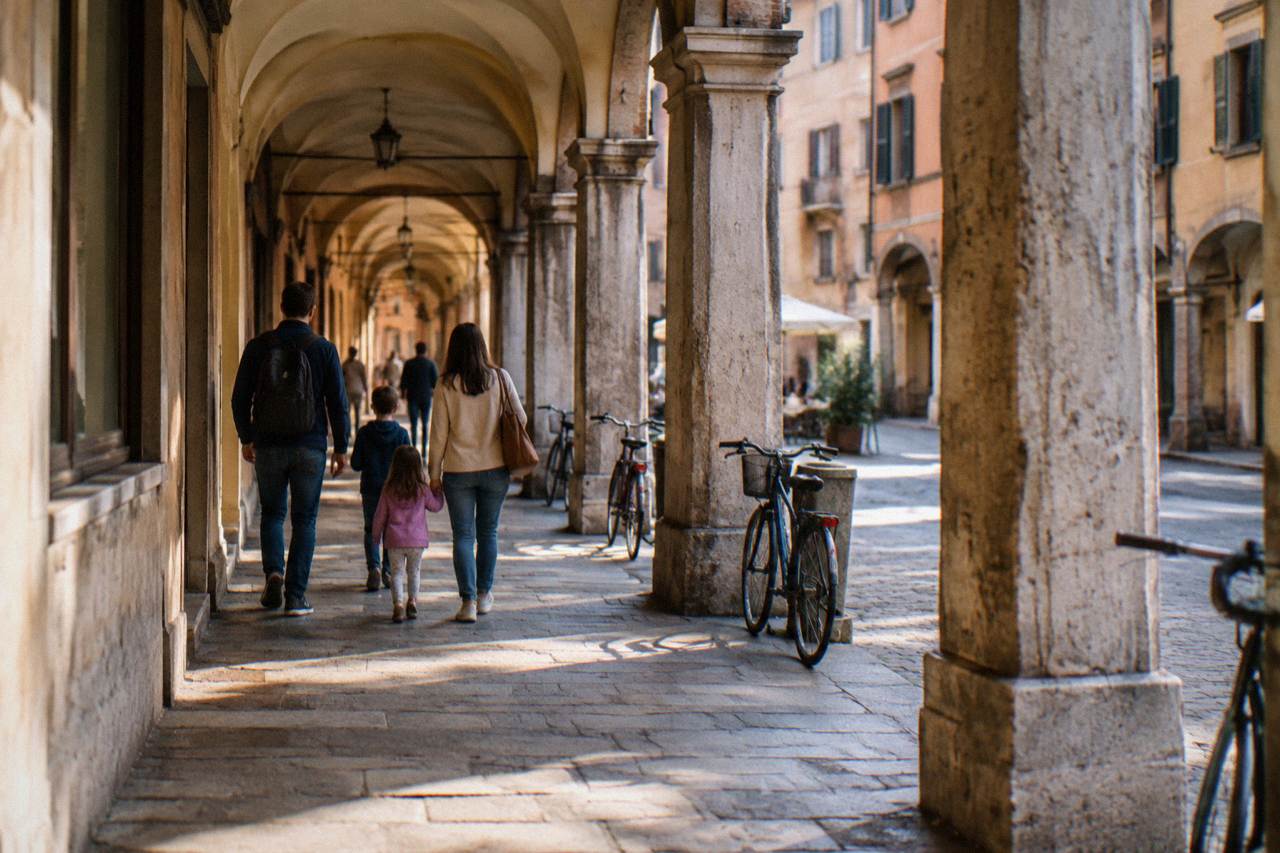 A family with two children walking through an arcaded street in central Padua