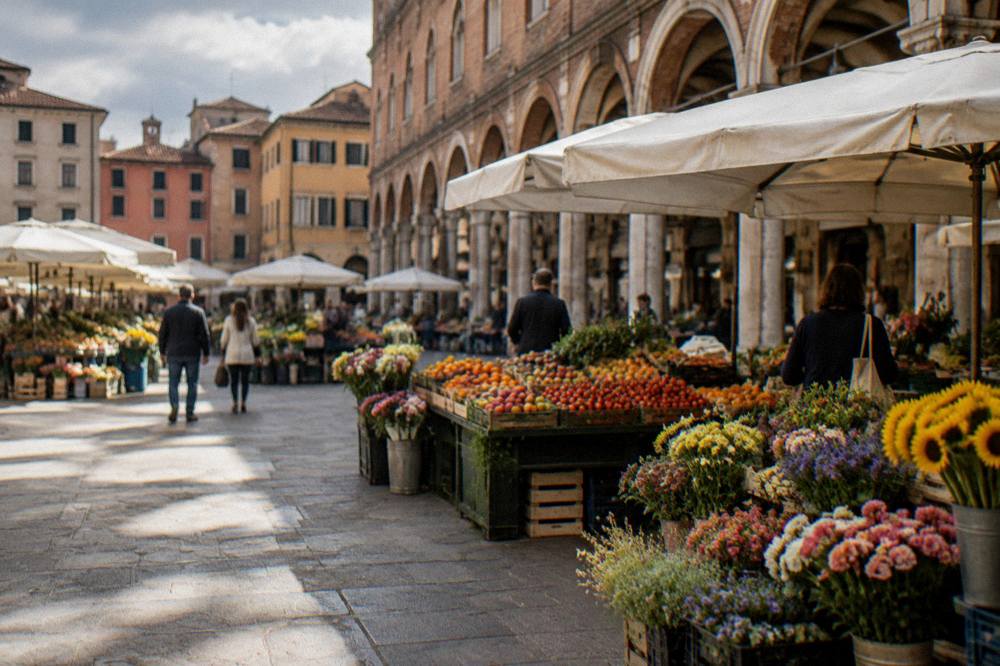 Market stalls with fruit and flowers under the arcades of Piazza delle Erbe in Padua