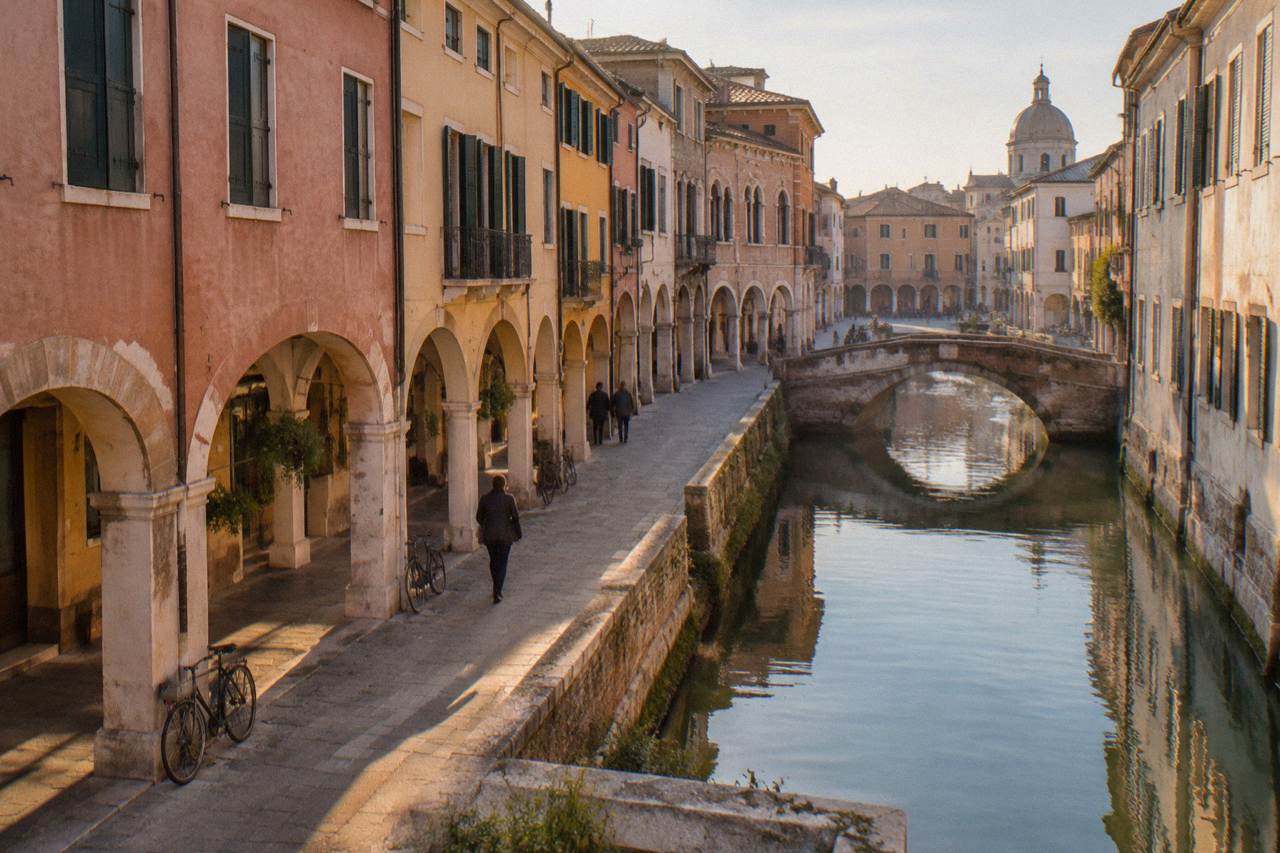 Arcaded street in central Padua with historic buildings under a daytime sky